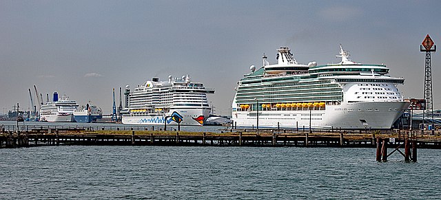 Three different cruise ships lined up at port. Navigator of the Seas, Aurora, and AIDAprima.