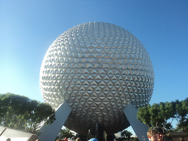 Spaceship Earth, one of the best slow rides at EPCOT for adults. Big white geodesic sphere surrounded by green trees.