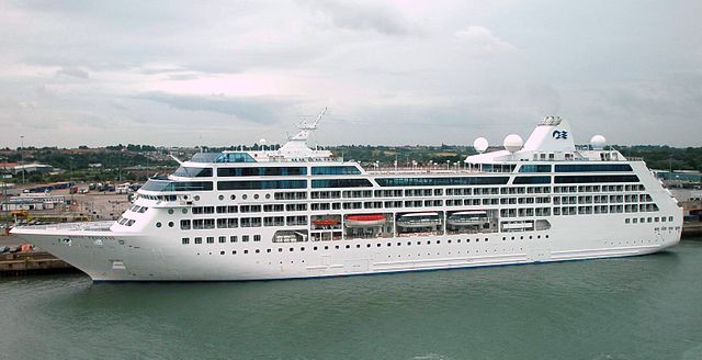 Princess Cruise Lines Royal Princess. White cruise ship docked at flat location.