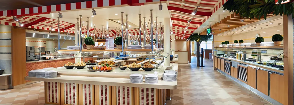 Stop by the Lido Marketplace Midnight Buffet on Carnival Cruise. Buffet offerings with red and white overhang. 