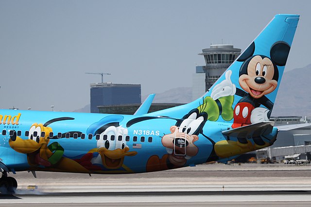 Disney World themed airplane with Pluto, Donald Duck, Goofy, and Mickey Mouse