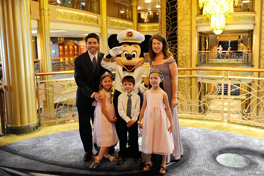 Formal Nights on Disney Cruise, also called Dress-Up Night. Family in Formal Attire alongside Captain Mickey, who is also dressed in  Formal Attire.