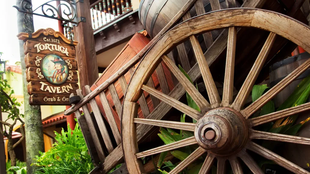 Entrance to Tortuga Tavern, spot for Turkey Legs in Adventureland in Magic Kingdom. Large wooden cart with barrels inside.